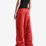Red pants worn by a person, showing the pants fit