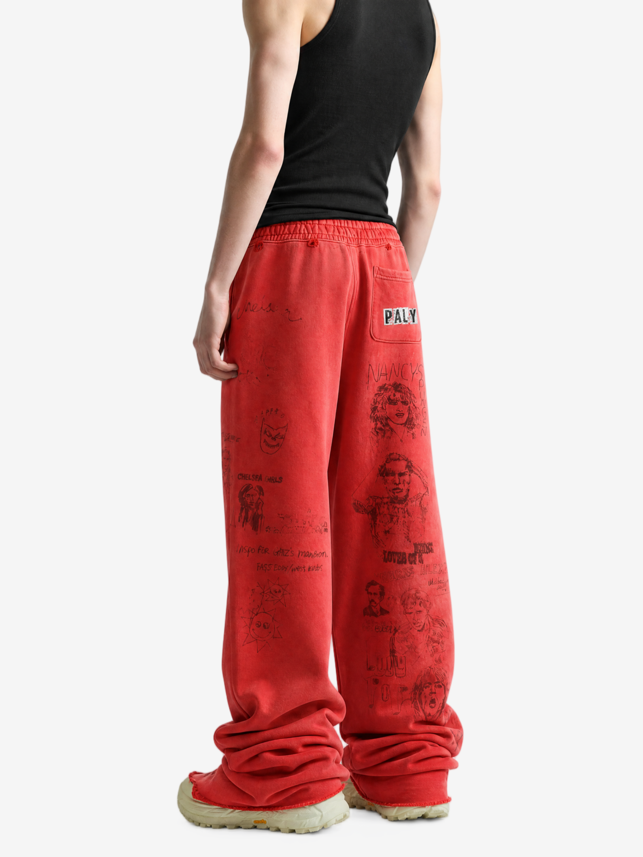 Red pants worn by a person, showing the pants fit