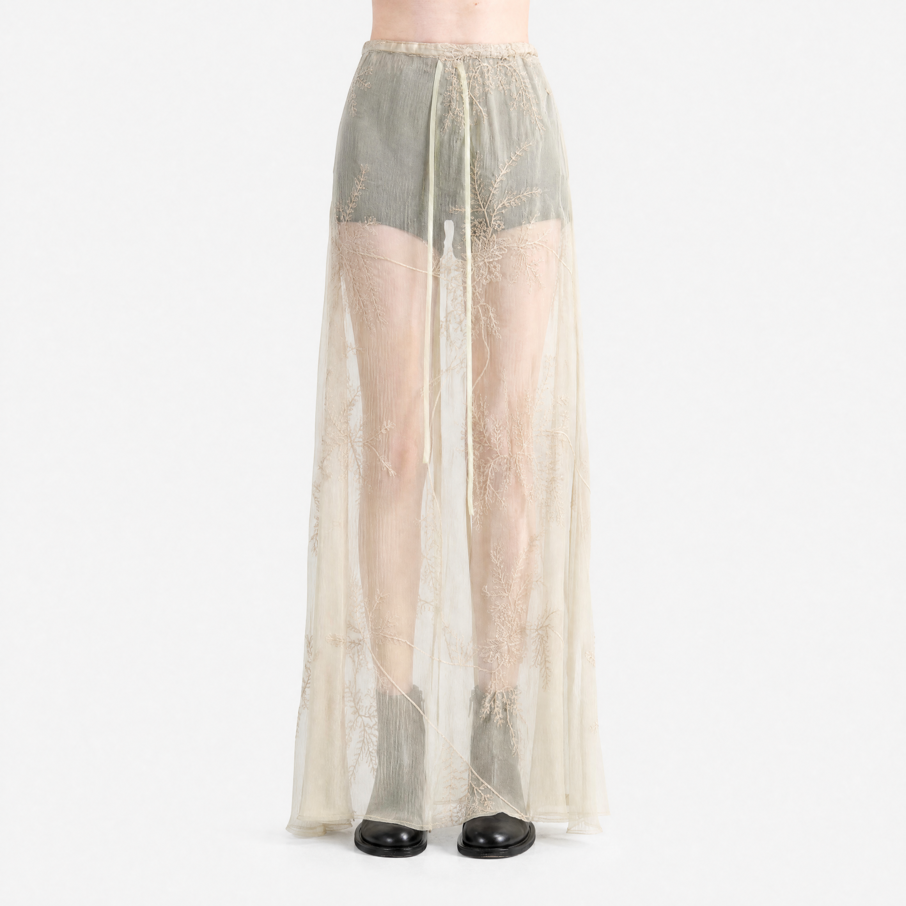 tan skirt worn by a person, showing the skirt  fit