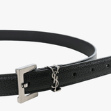 Close up of black belt, showing texture of the leather fabric