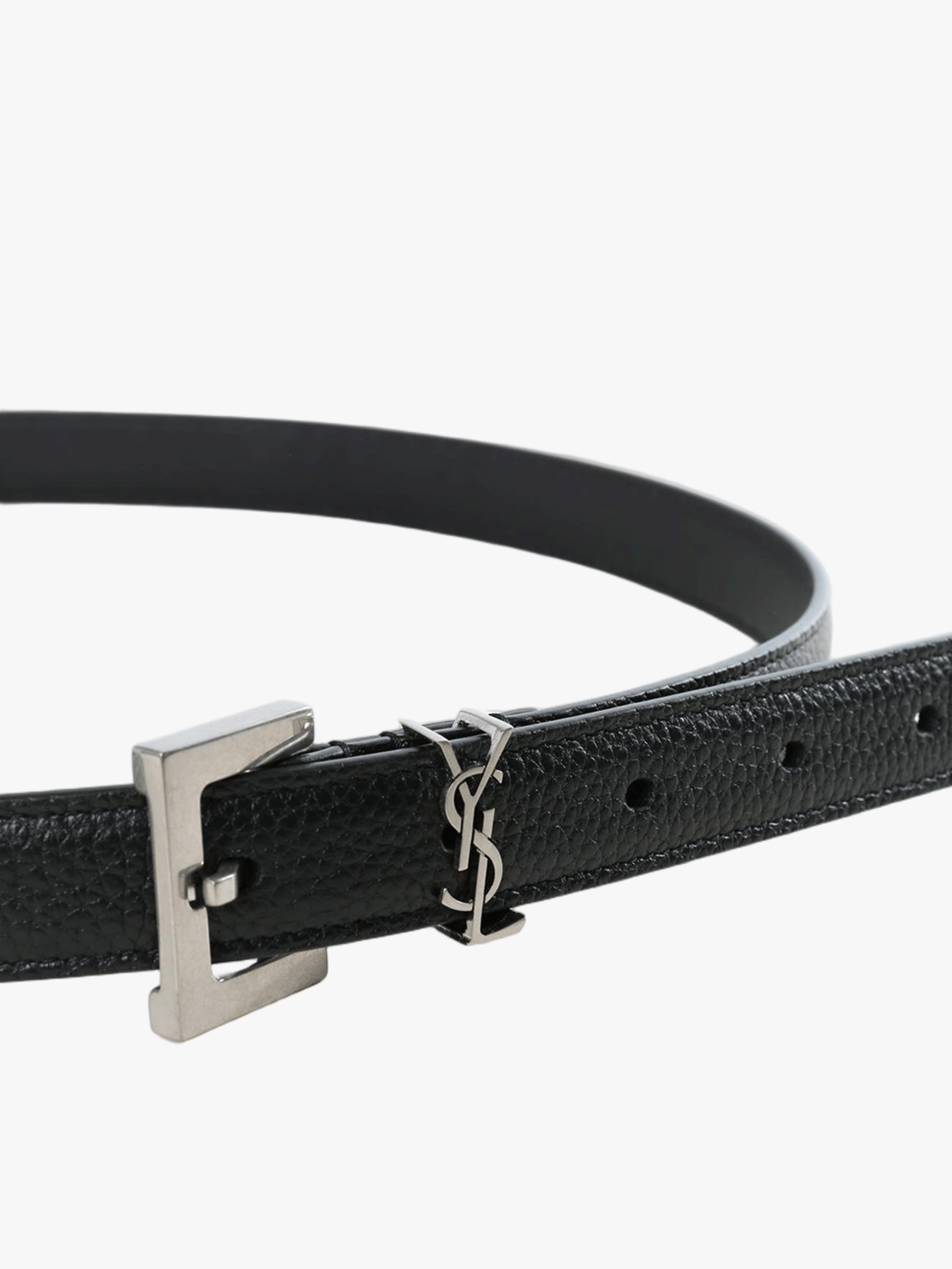 Close up of black belt, showing texture of the leather fabric