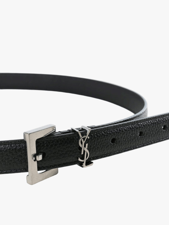 Close up of black belt, showing texture of the leather fabric