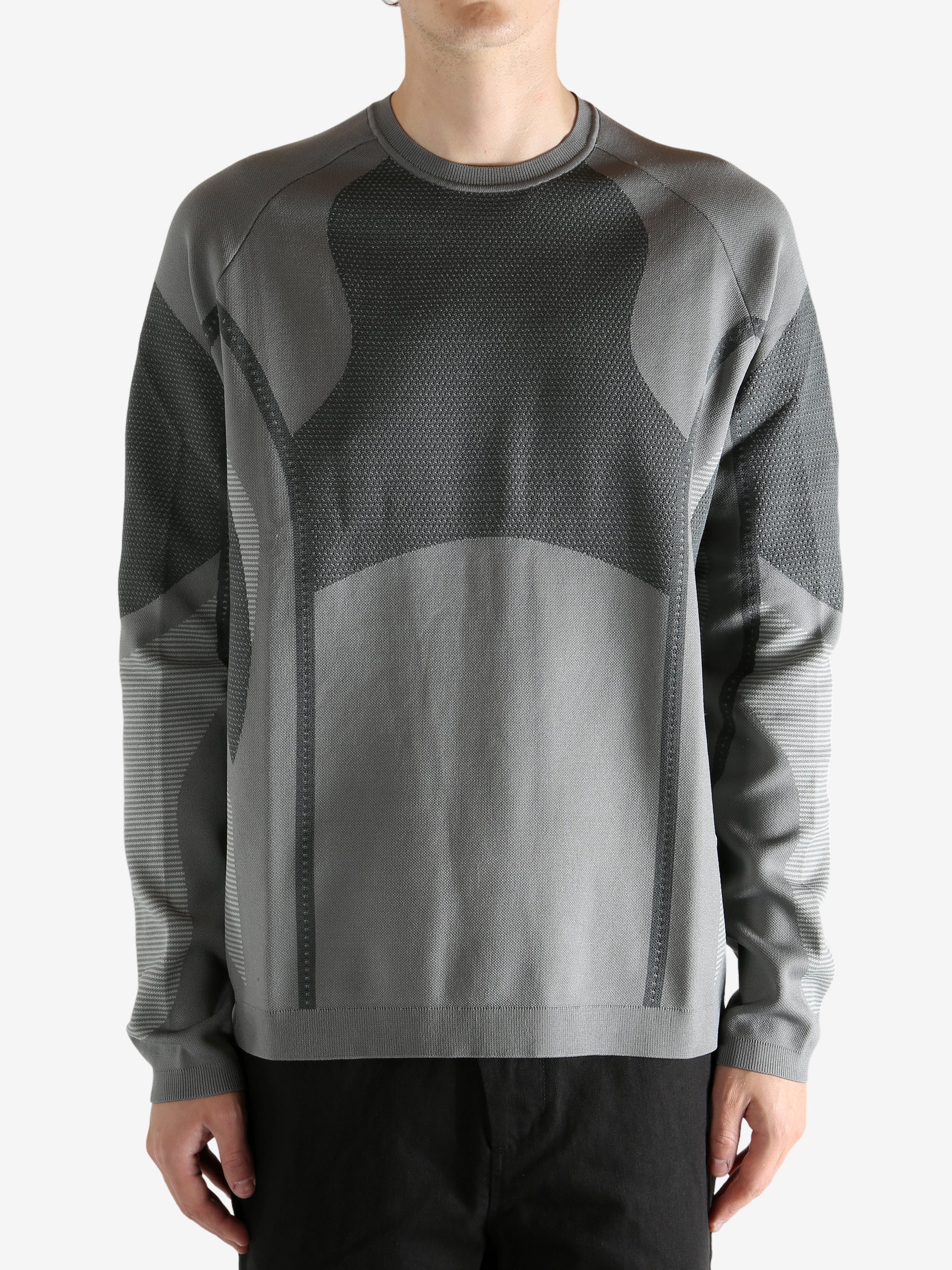 grey  sweater worn by a person, showing the sweater's fit