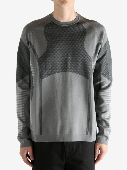 grey  sweater worn by a person, showing the sweater's fit