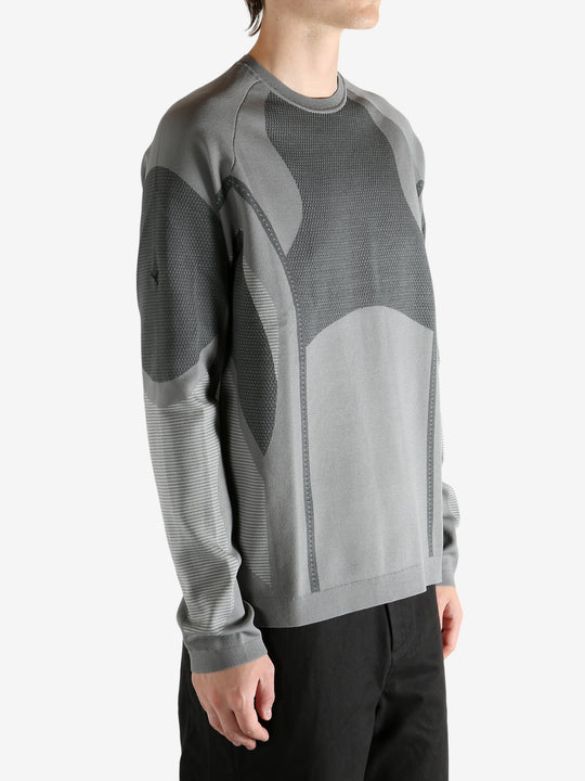 grey  sweater worn by a person, showing the sweater's fit