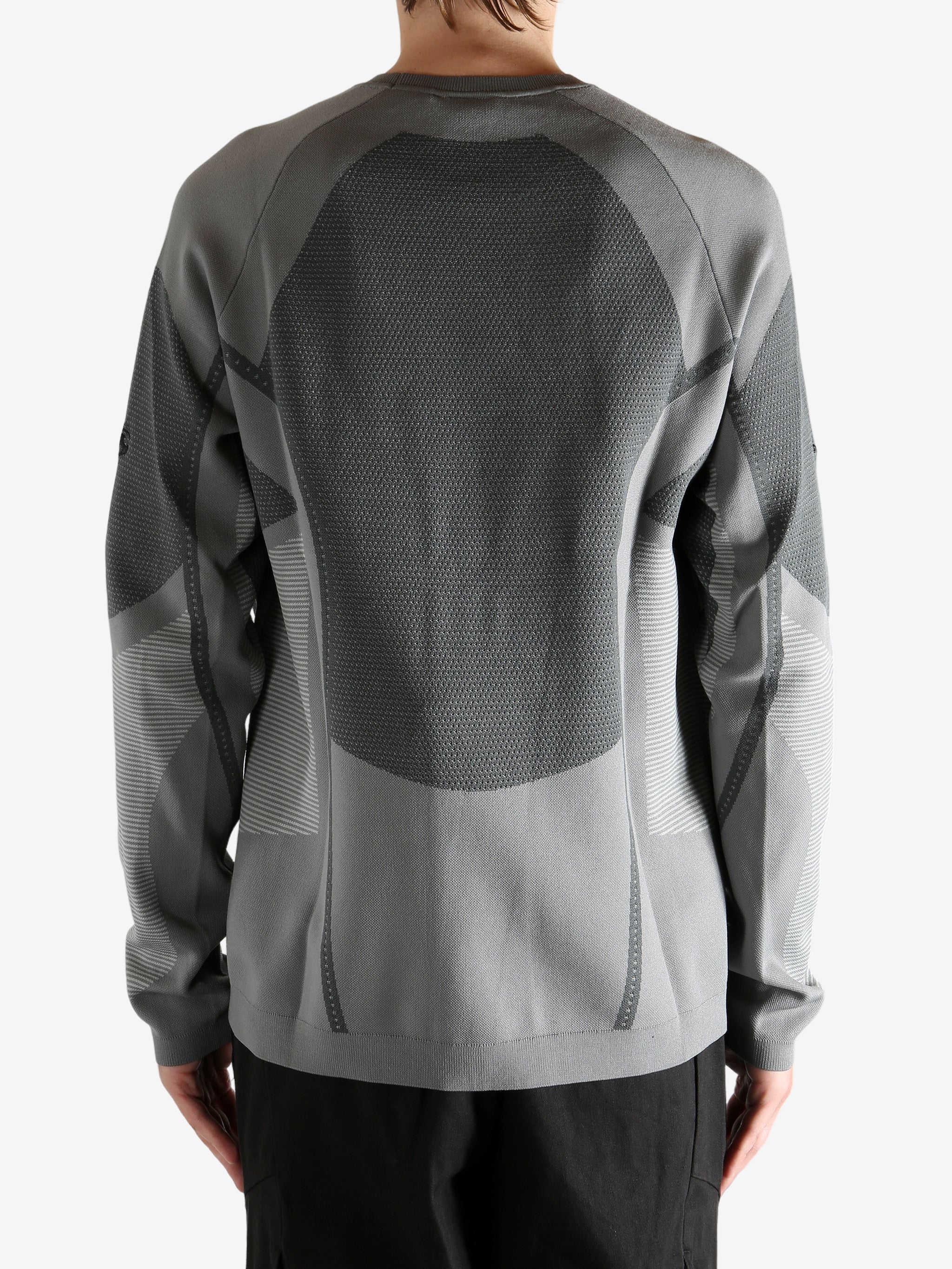 grey  sweater worn by a person, showing the sweater's fit