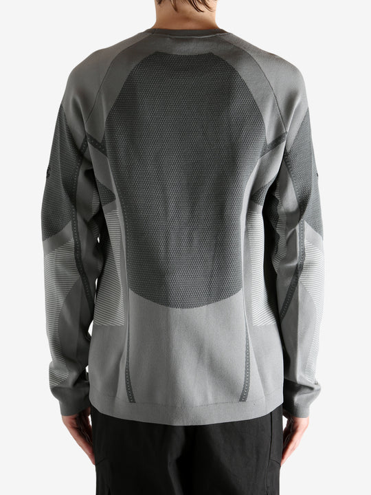 grey  sweater worn by a person, showing the sweater's fit