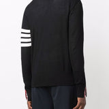 Black knitwear worn by a person, showing the knitwear’s fit