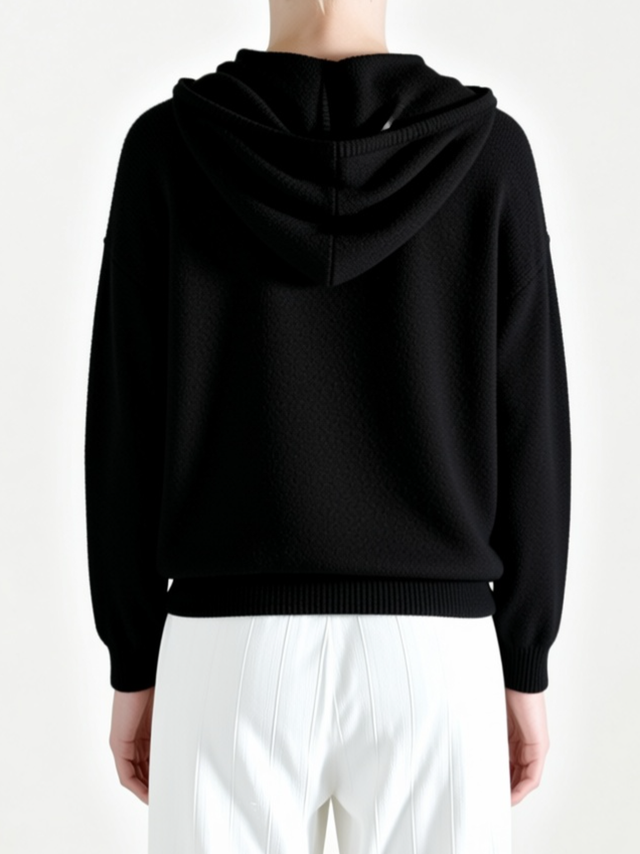 Black hoodie worn by a person, back view