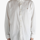 White shirt worn by a person, showing the shirt's fit