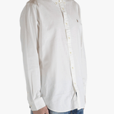 White shirt worn by a person, showing the shirt's fit
