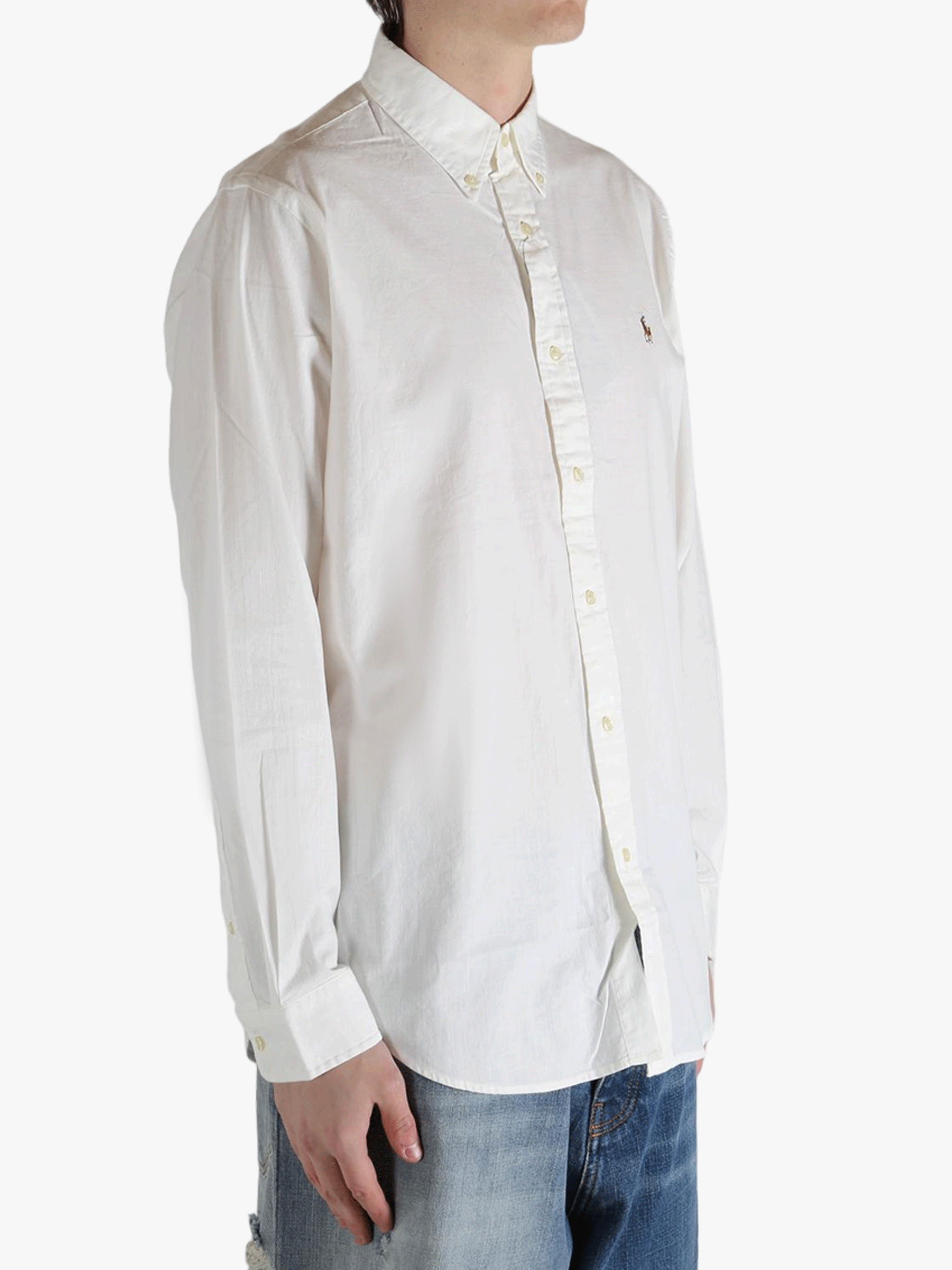 White shirt worn by a person, showing the shirt's fit