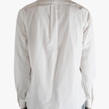 White shirt worn by a person, showing the shirt's fit
