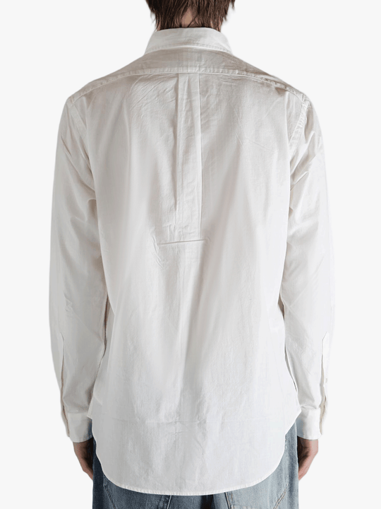 White shirt worn by a person, showing the shirt's fit