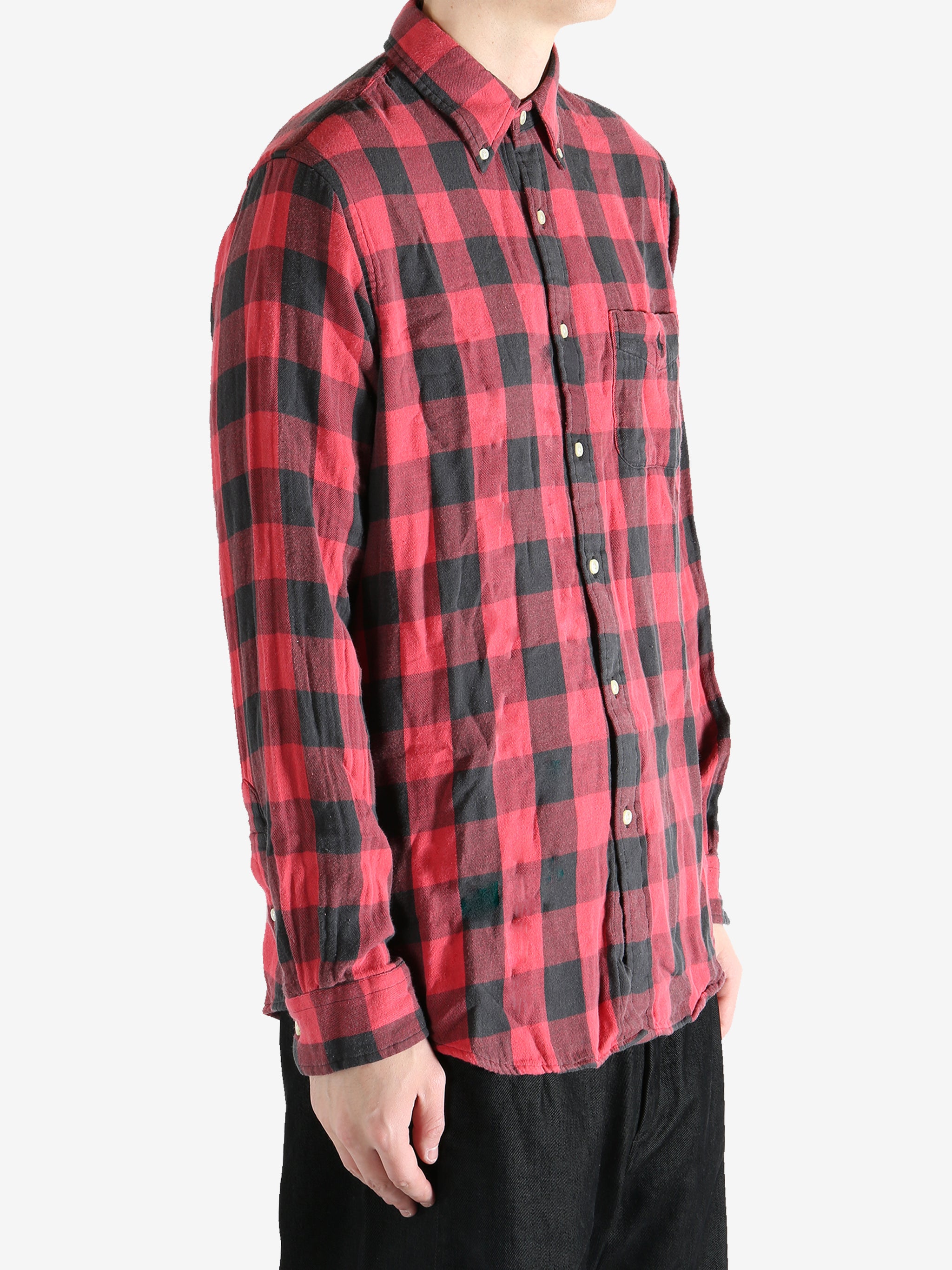 Red shirts worn by a person, showing the shirts fit