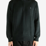 Black knitwear worn by a person, showing the knitwear's fit