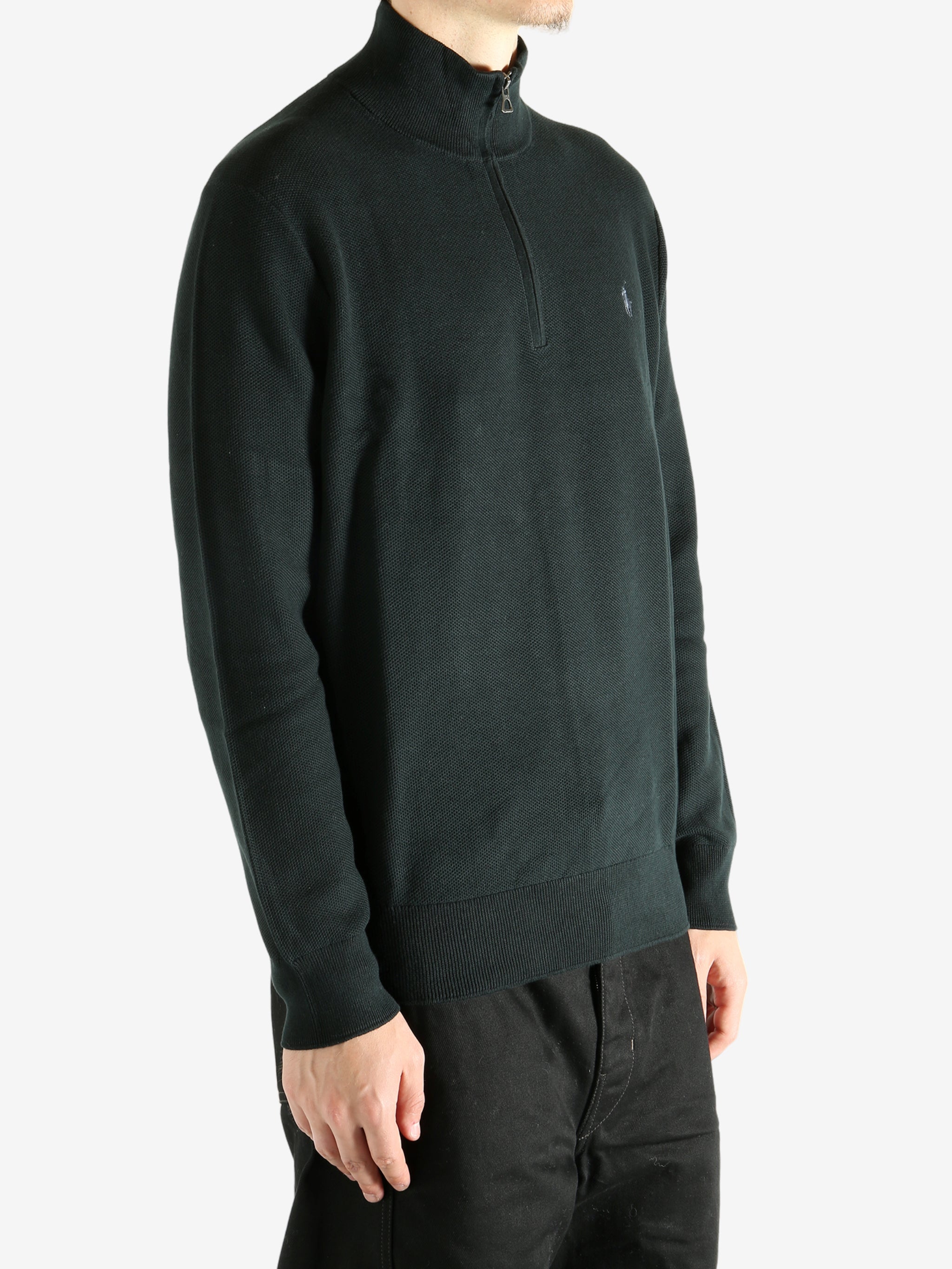 Black knitwear worn by a person, showing the knitwear's fit