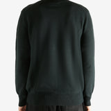 Black knitwear worn by a person, showing the knitwear's fit
