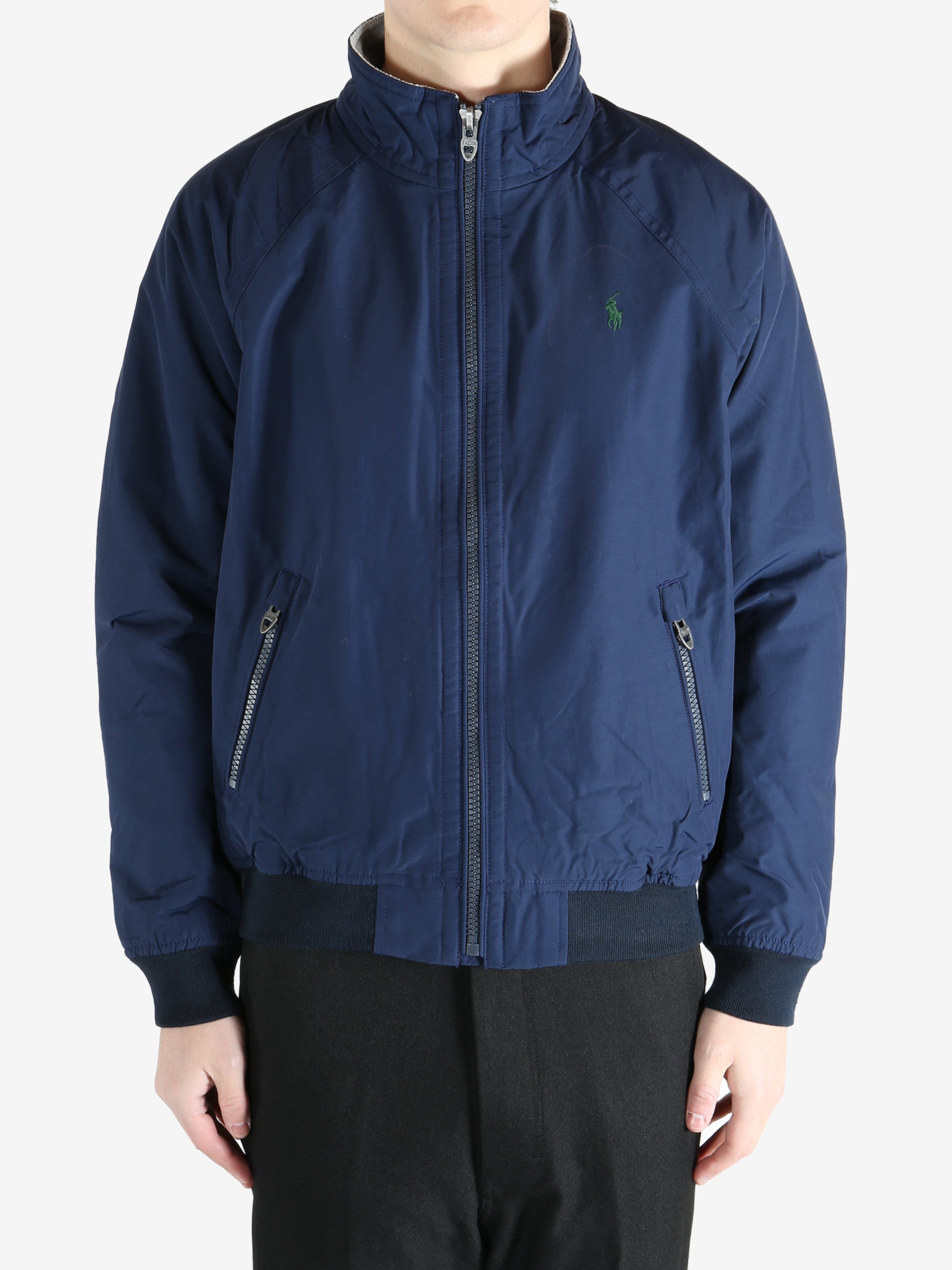 Navy jacket worn by a person, showing the  jacket fit