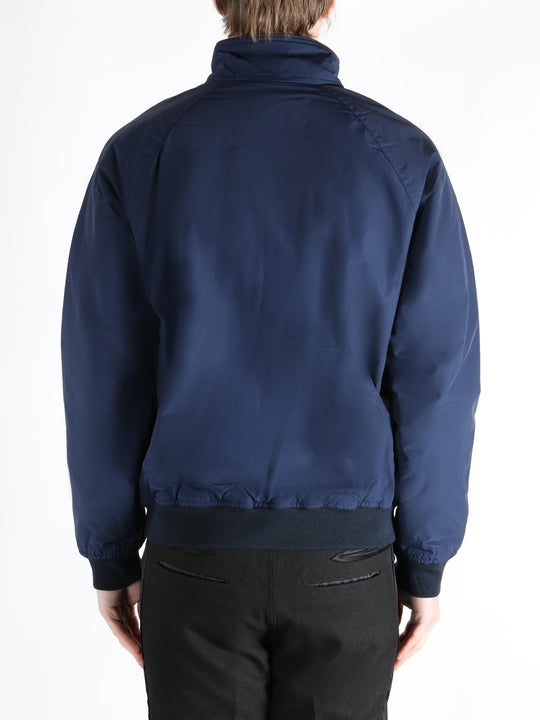 Navy jacket worn by a person, showing the  jacket fit