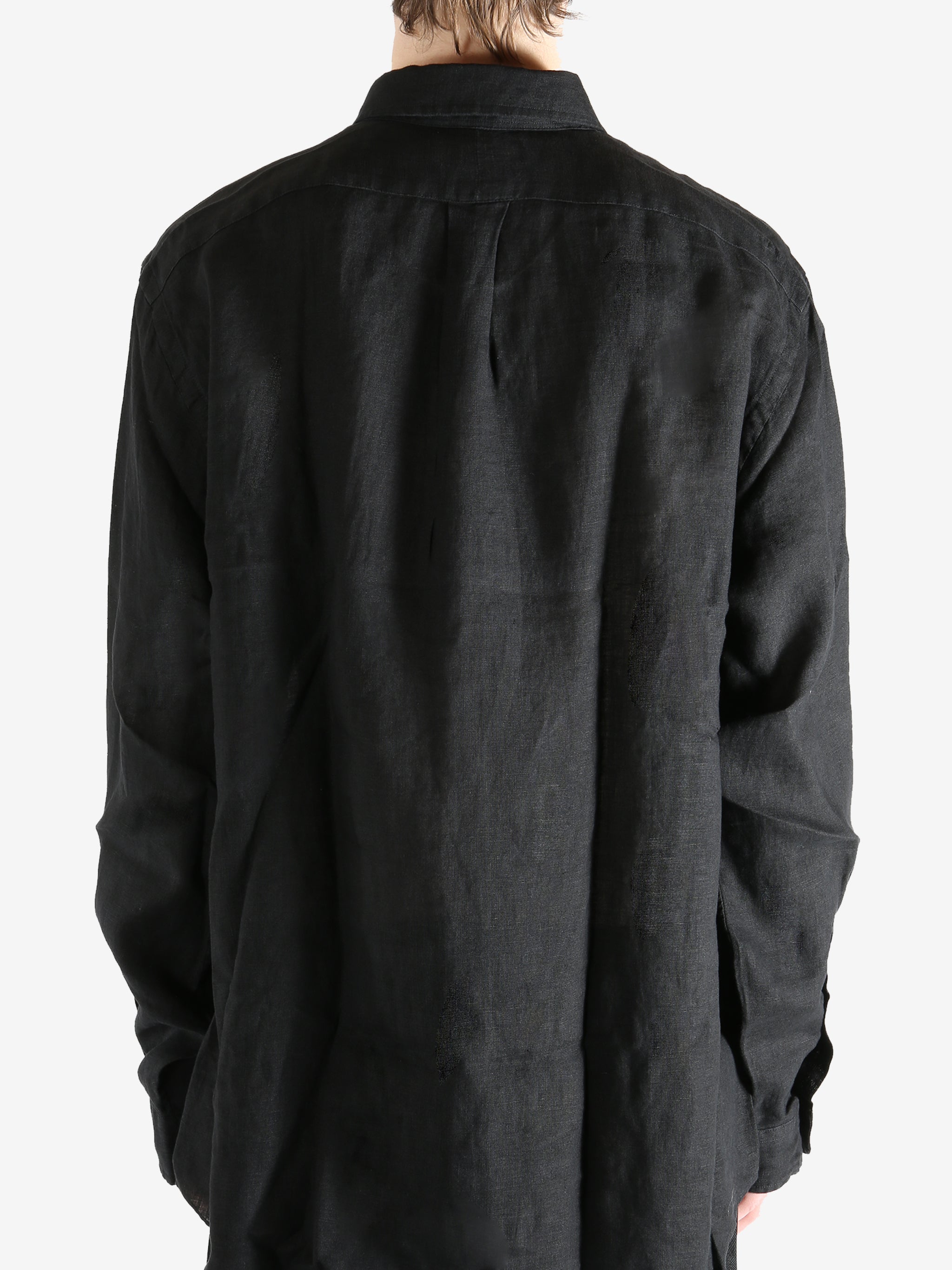 Black shirts worn by a person, showing the shirts fit