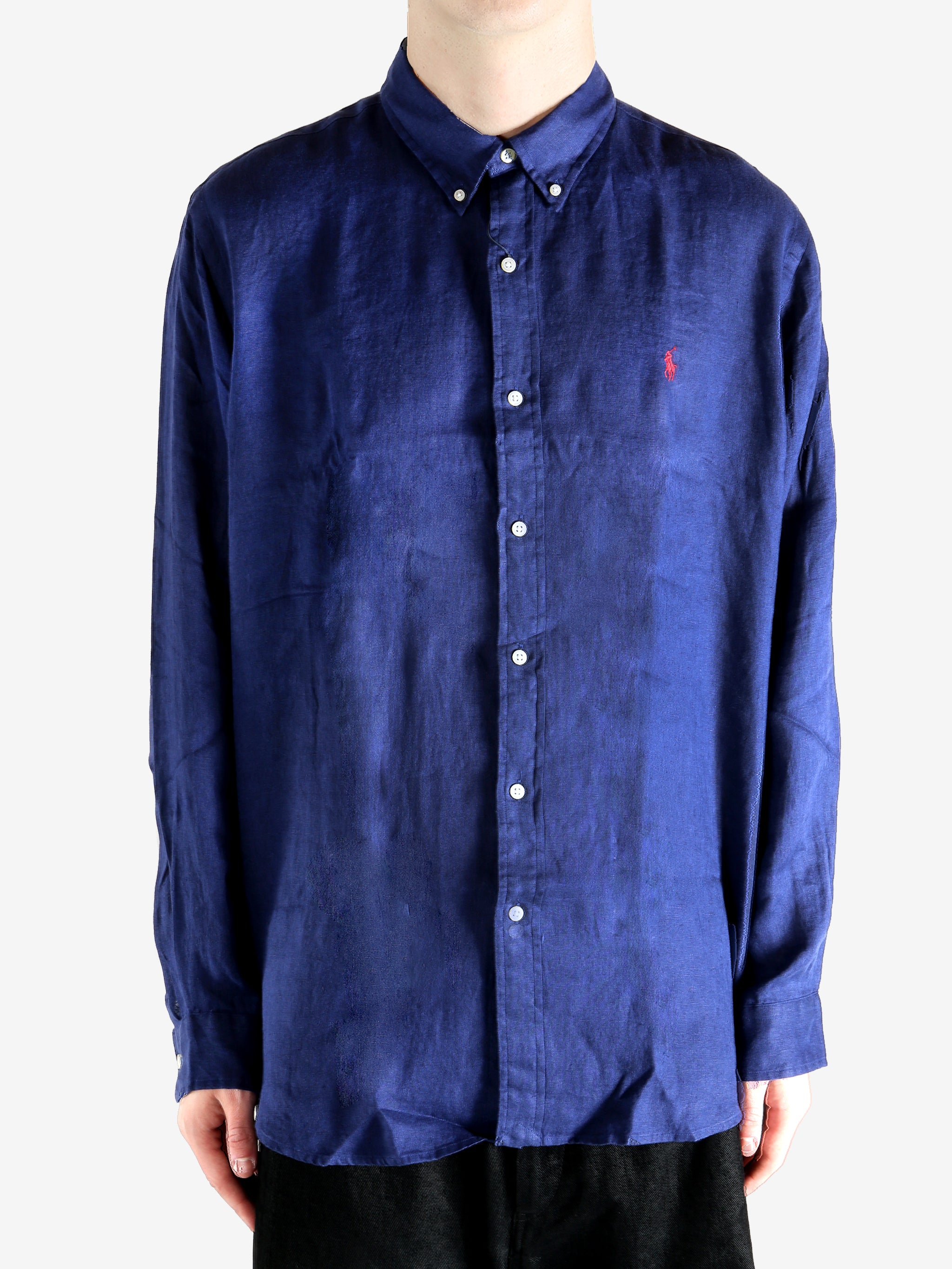 Navy shirts worn by a person, showing the shirts fit