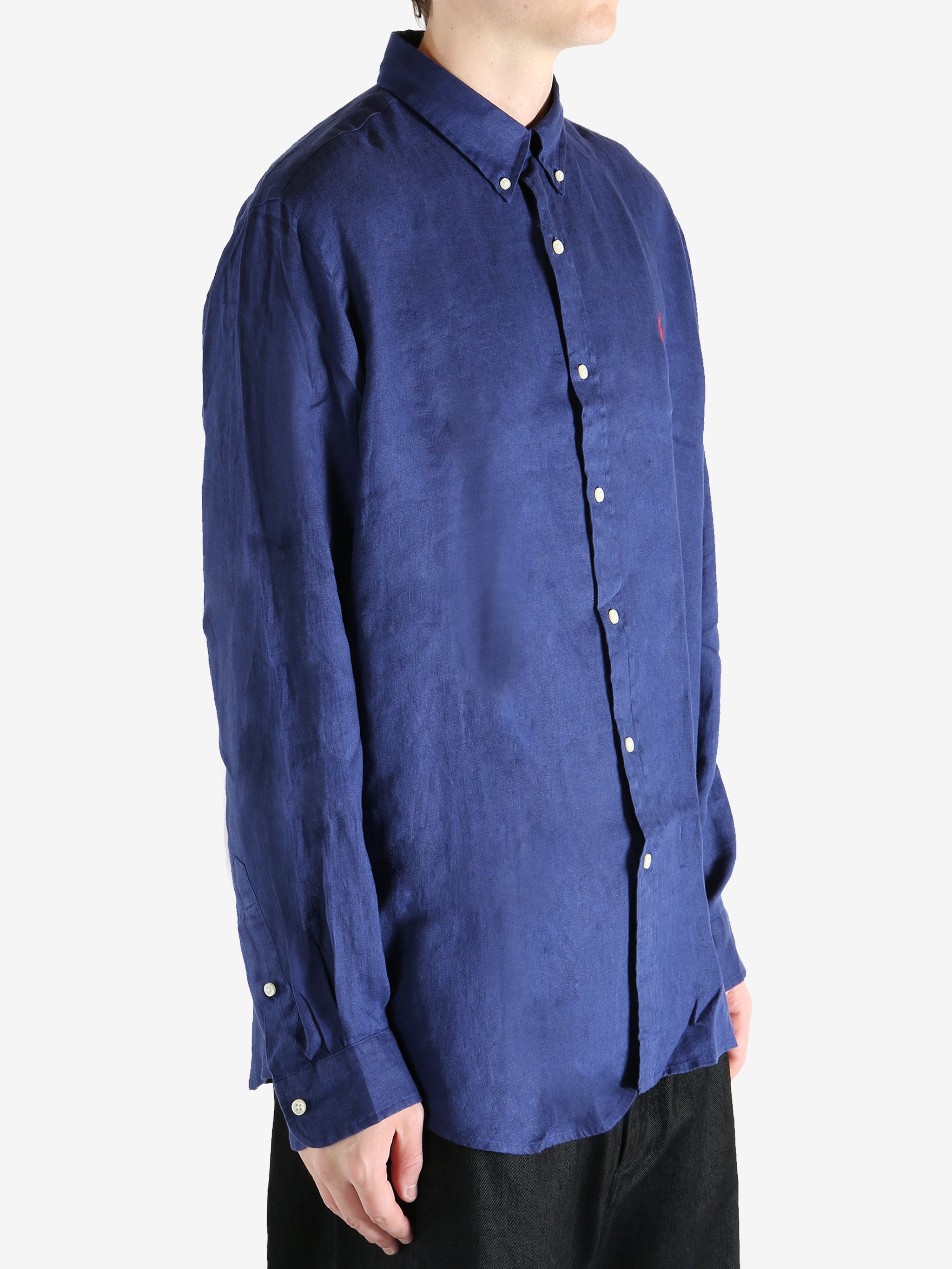 Navy shirts worn by a person, showing the shirts fit