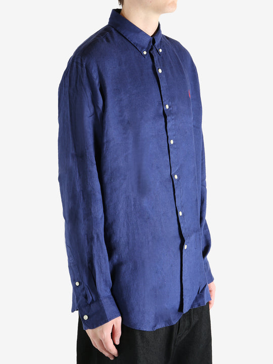 Navy shirts worn by a person, showing the shirts fit