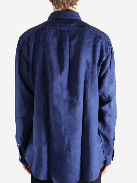 Navy shirts worn by a person, showing the shirts fit