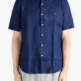 Navy shirts worn by a person, showing the shirts fit