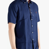 Navy shirts worn by a person, showing the shirts fit