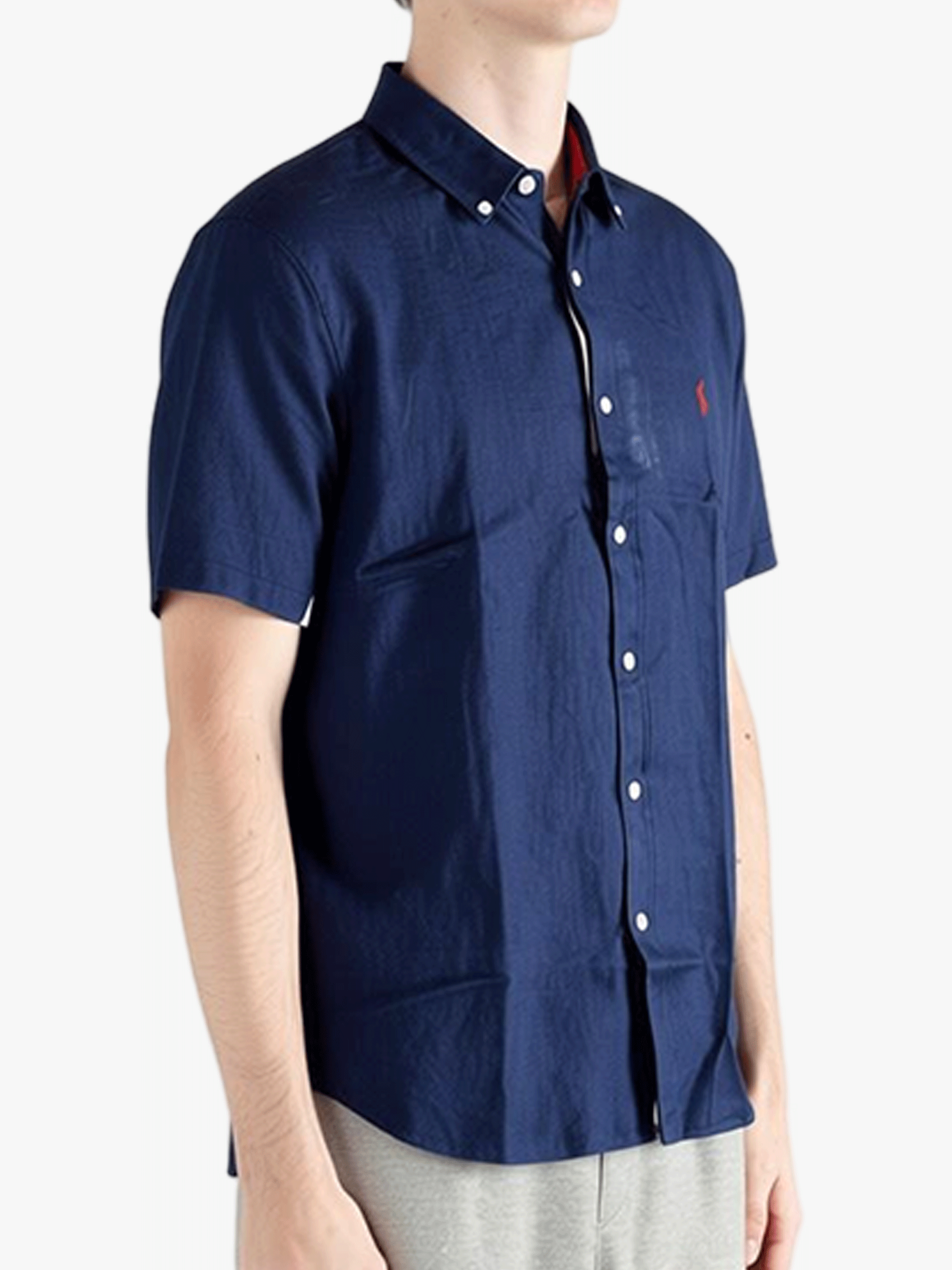 Navy shirts worn by a person, showing the shirts fit