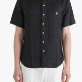 Black shirt worn by a person, showing the shirt fit