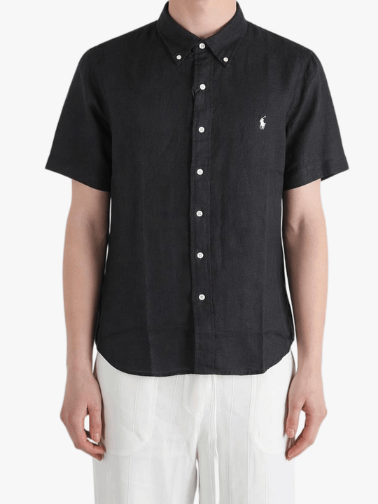 Black shirt worn by a person, showing the shirt fit