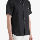 Black shirt worn by a person, showing the shirt fit