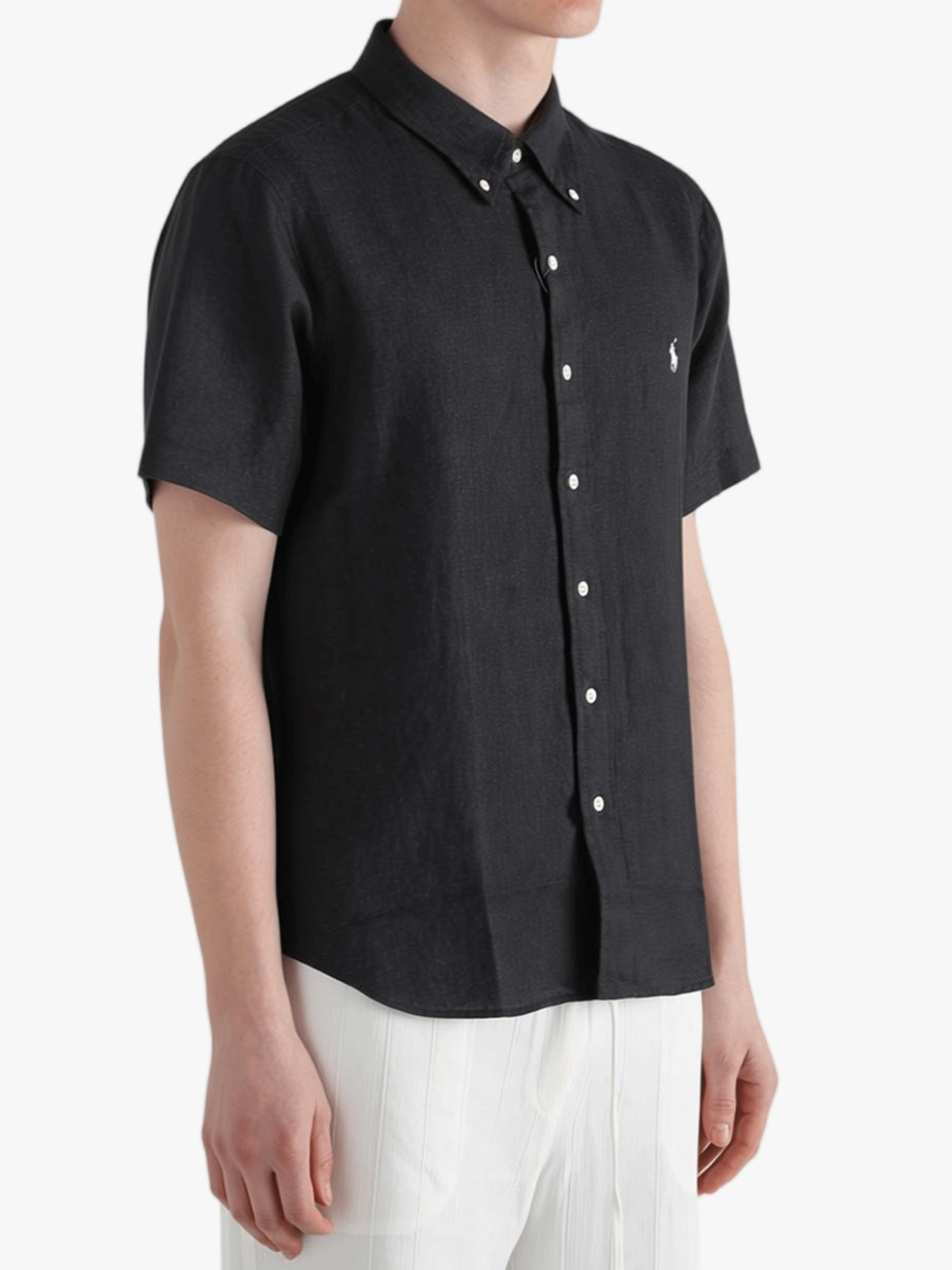 Black shirt worn by a person, showing the shirt fit