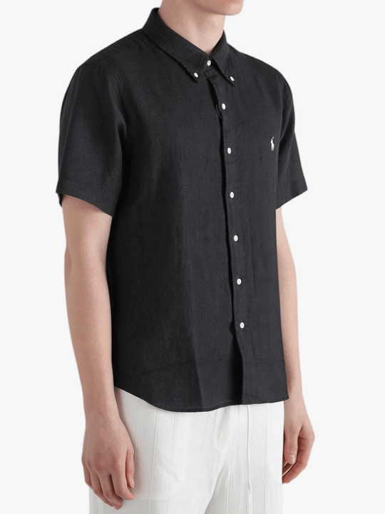 Black shirt worn by a person, showing the shirt fit