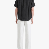Black shirt worn by a person, showing the shirt fit