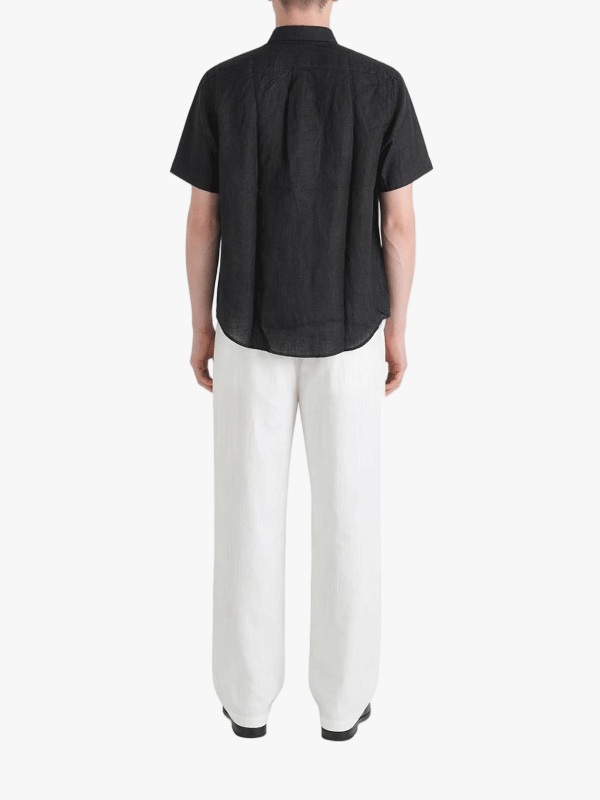 Black shirt worn by a person, showing the shirt fit