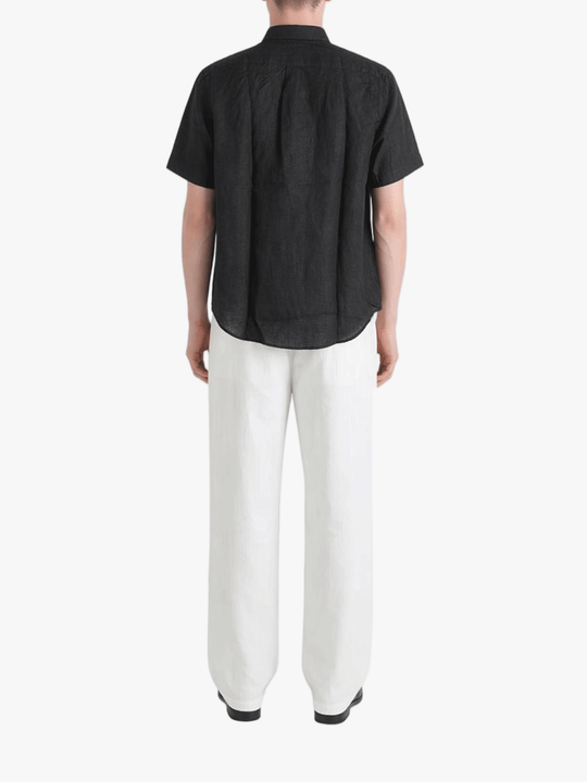 Black shirt worn by a person, showing the shirt fit
