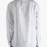 Blue shirt worn by a person, showing the shirt's fit