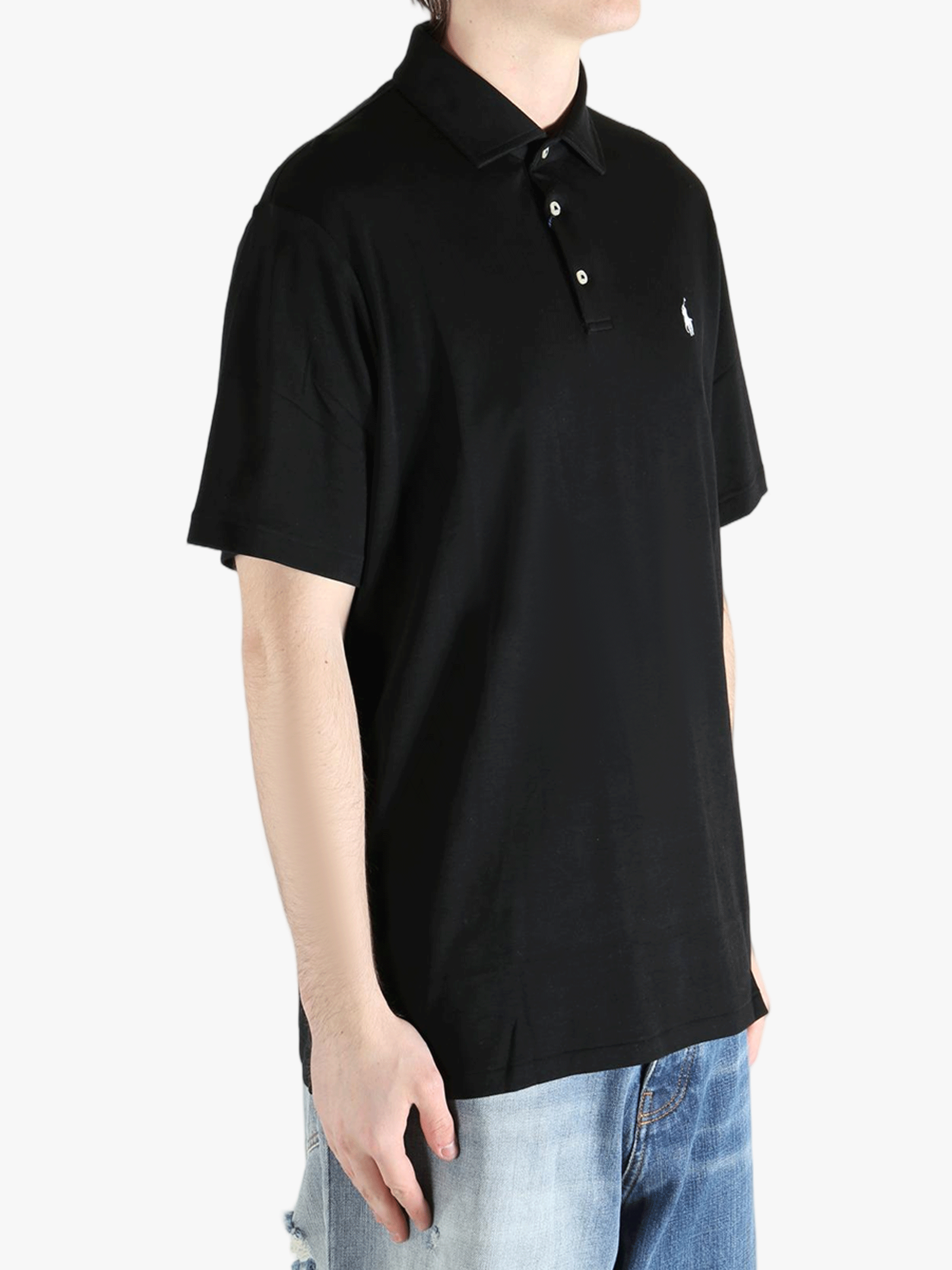 Black shirt worn by a person, showing the shirt's fit