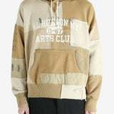 Tan hoodie worn by a person, showing the hoodie's fit