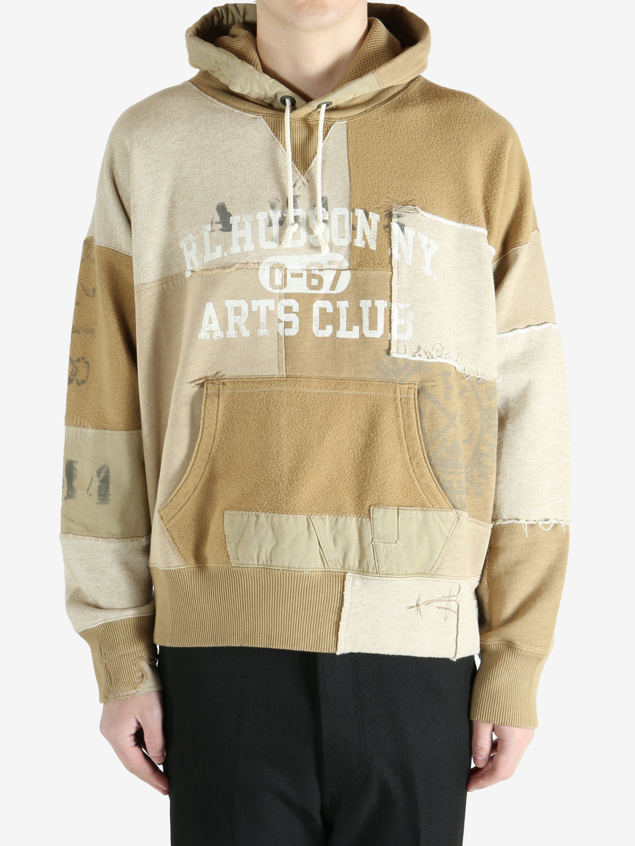 Tan hoodie worn by a person, showing the hoodie's fit