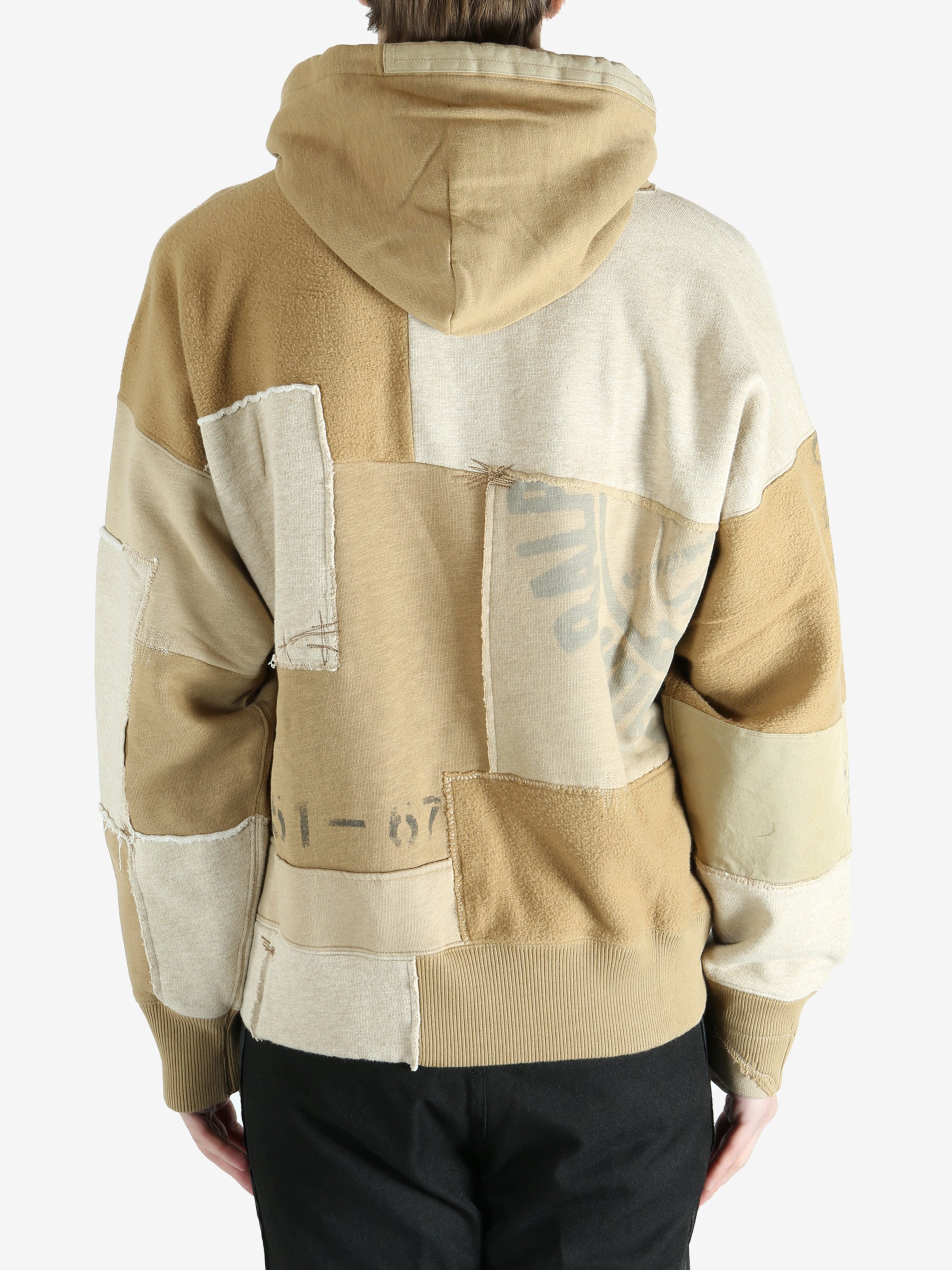 Tan hoodie worn by a person, showing the hoodie's fit