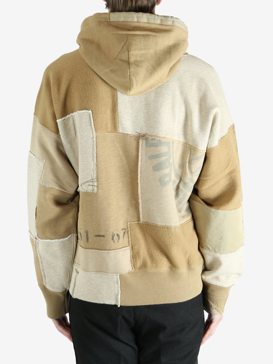 Tan hoodie worn by a person, showing the hoodie's fit