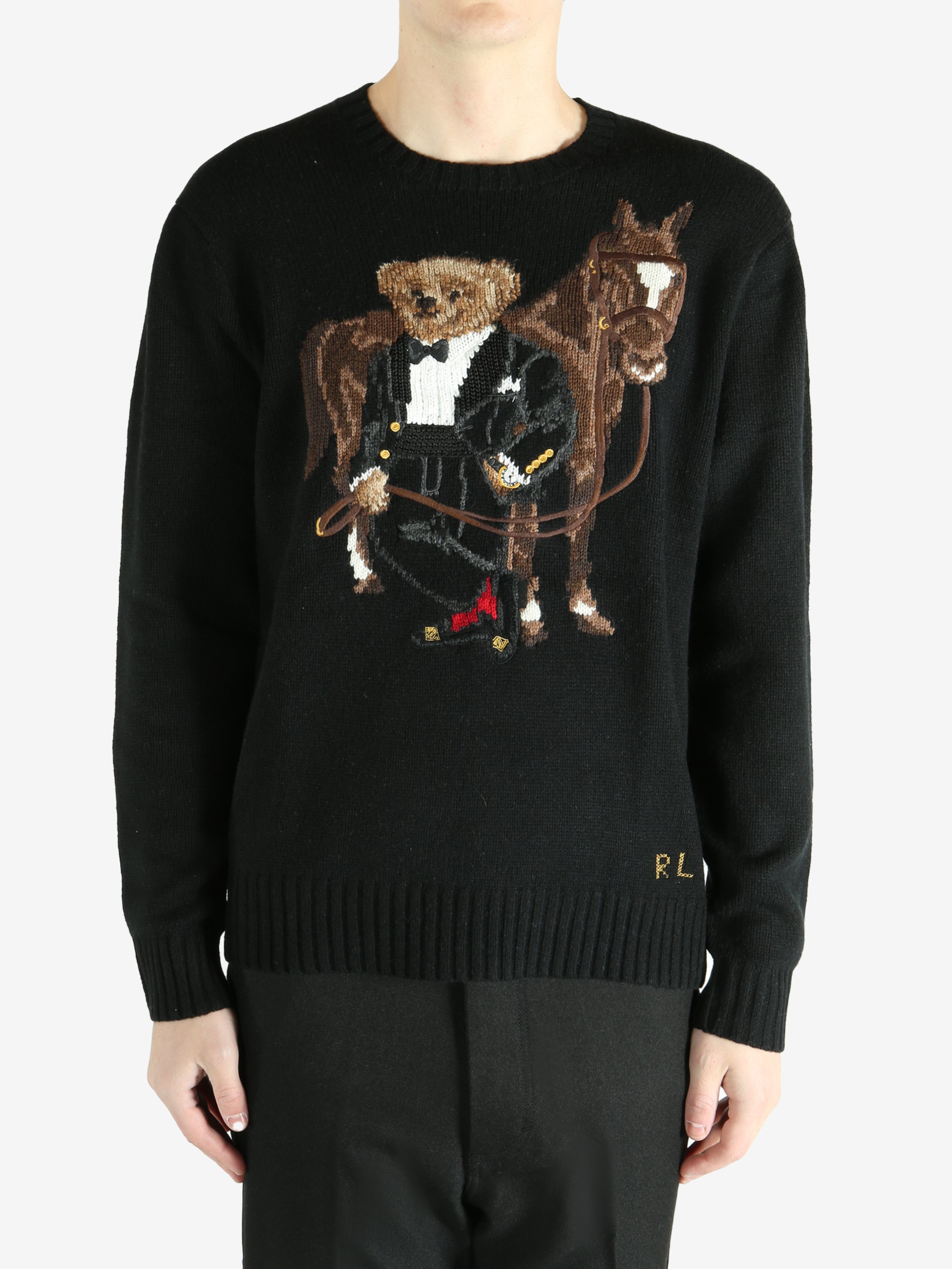 Black sweater worn by a person, showing the sweater's fit