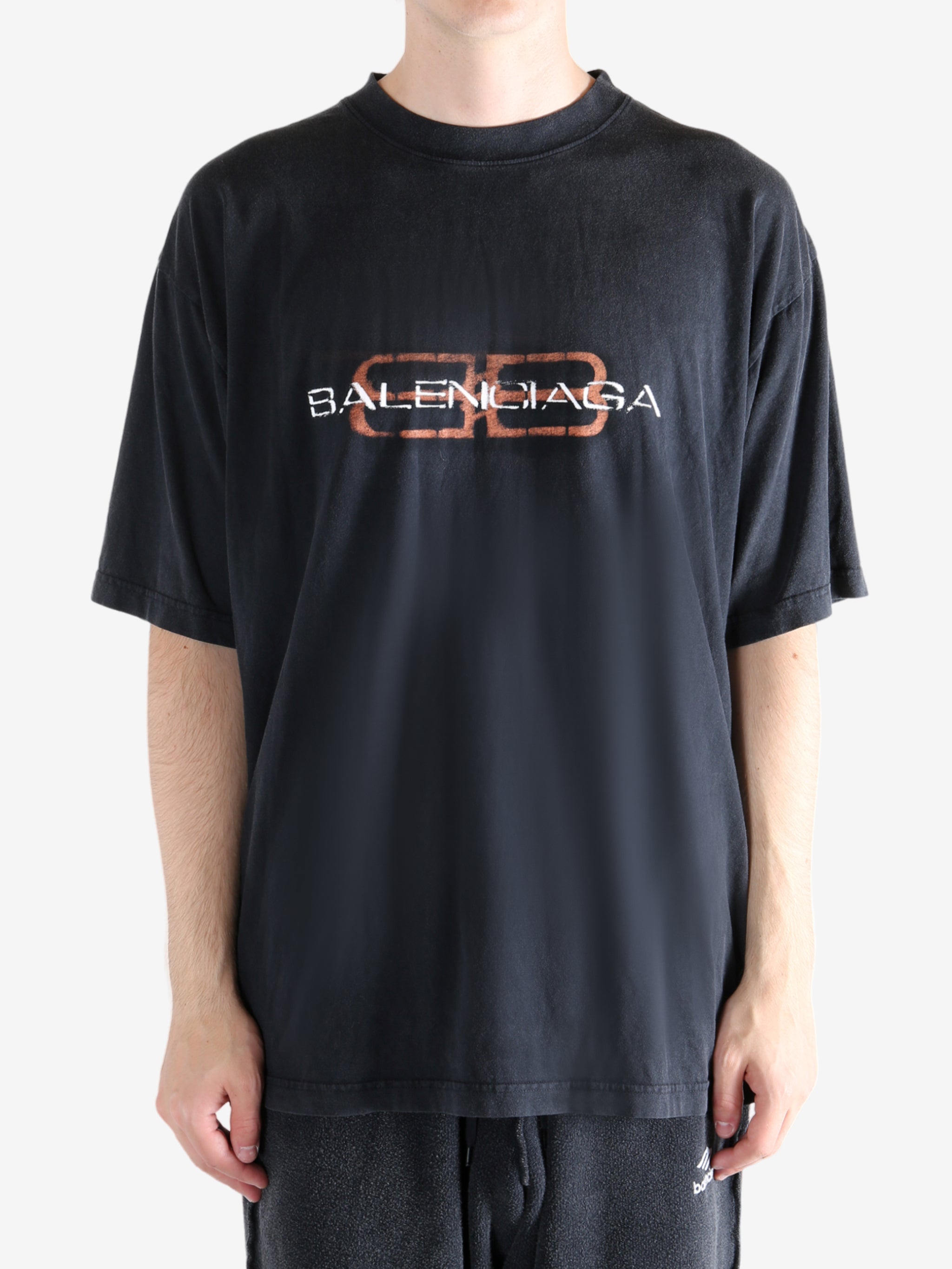 Black t-shirt worn by a person, showing the t-shirt's fit