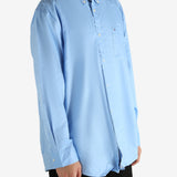 Blue shirt worn by a person, showing the shirt's fit