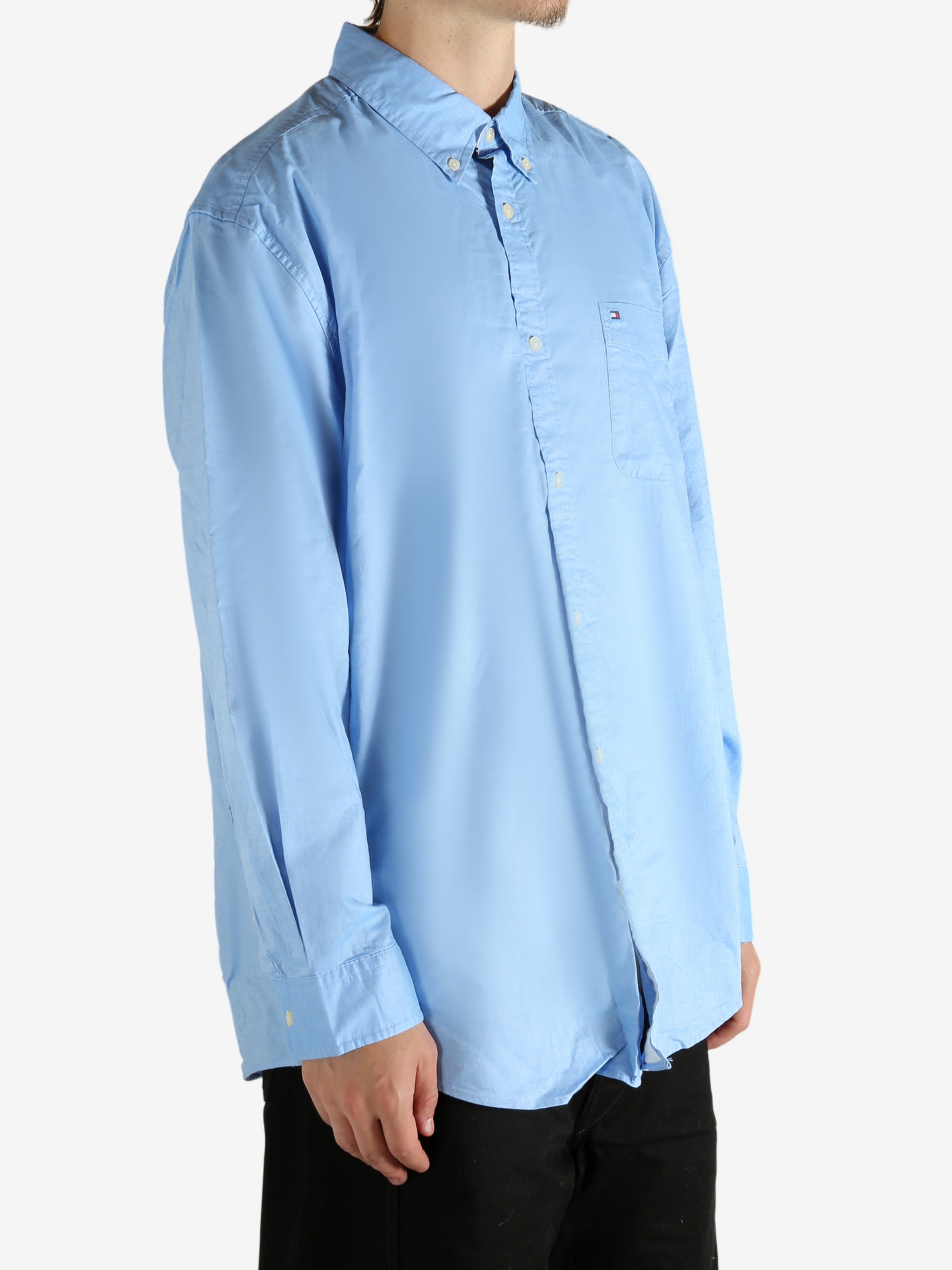 Blue shirt worn by a person, showing the shirt's fit